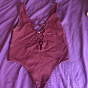 Burgundy tie up bodysuit.